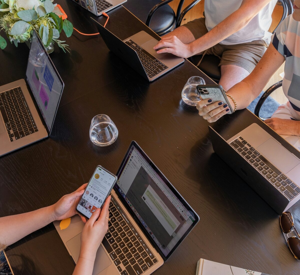 a-group-of-people-sitting-around-a-table-with-laptops-stockpack-unsplash.jpg a group of people sitting around a table with laptops