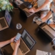 a-group-of-people-sitting-around-a-table-with-laptops-stockpack-unsplash.jpg a group of people sitting around a table with laptops