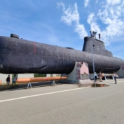 a-large-black-submarine-sitting-on-top-of-a-road-stockpack-unsplash.jpg a large black submarine sitting on top of a road