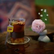 Cozy tea setting with pink rose on wooden table