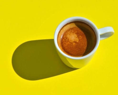 Cup of coffee on a table in the sun