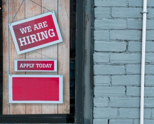 we-are-hiring-sign-in-window-of-brick-building-a-red-and-white-sign-in-a-window-of-a-brick-building-reads-we-are-hiring-with-a-smaller-sign-that-says-apply-today-stockpack-unsplash.jpg "We Are Hiring" Sign in Window of Brick Building - A red and white sign in a window of a brick building reads We Are Hiring with a smaller sign that says Apply Today.