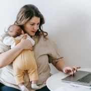 young-working-mother-cuddling-baby-and-using-laptop-at-home-stockpack-pexels.jpg Young working mother cuddling baby and using laptop at home