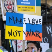 a-man-holding-a-sign-that-says-make-love-not-war-stockpack-unsplash.jpg