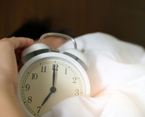 Photo of person holding alarm clock