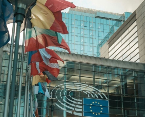 a-group-of-flags-flying-in-front-of-a-building-stockpack-unsplash.jpg