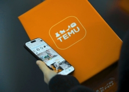 A Temu parcel/box with a phone