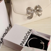 Elegant white handbag with pandora jewelry