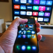 Hand holding smartphone with streaming apps