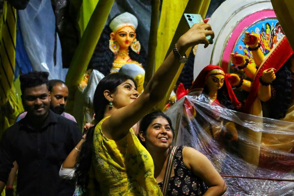 two-women-take-a-selfie-with-idols-in-the-background-stockpack-unsplash.jpg