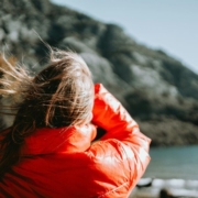 a-woman-in-a-red-jacket-looking-at-the-water-stockpack-unsplash.jpg