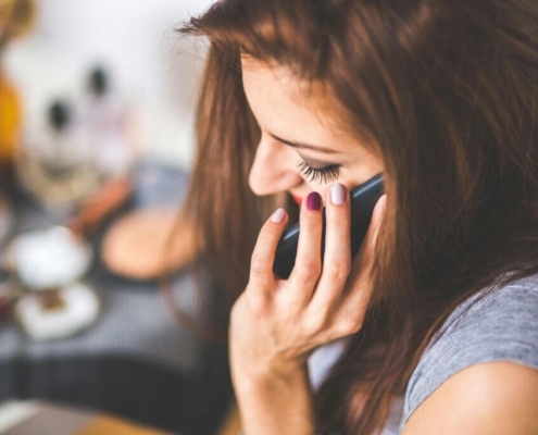 Closeup portrait of young lady talking on mobile phone