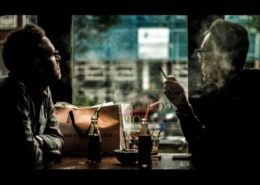 Two men in a coffee shop smoking