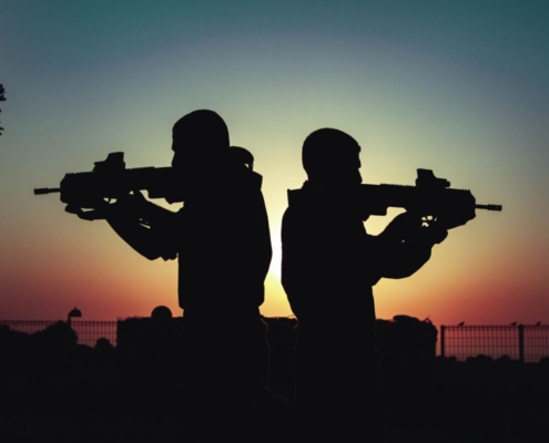 silhouette-of-men-holding-guns-stockpack-pexels.jpg Silhouette of men holding guns