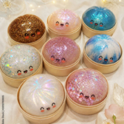 collection of eight cute kawaii glitter dumpling toys with smiley faces in various sparkle colors displayed in bamboo steamer boxes