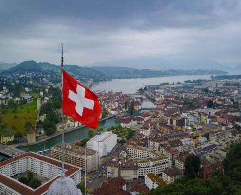 aerial-shot-of-swizz-flag-waving-over-lucerne-stockpack-pexels.jpg Aerial shot of swizz flag waving over lucerne